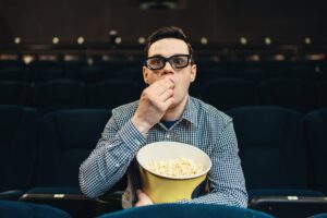 Teenager fascinated watching the film in cinema